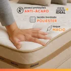 Mão pressionando colchão Gazin bege acolchoado com borda marrom.