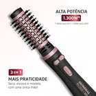 Escova rotativa Mondial preta e rosa com cerdas pretas.